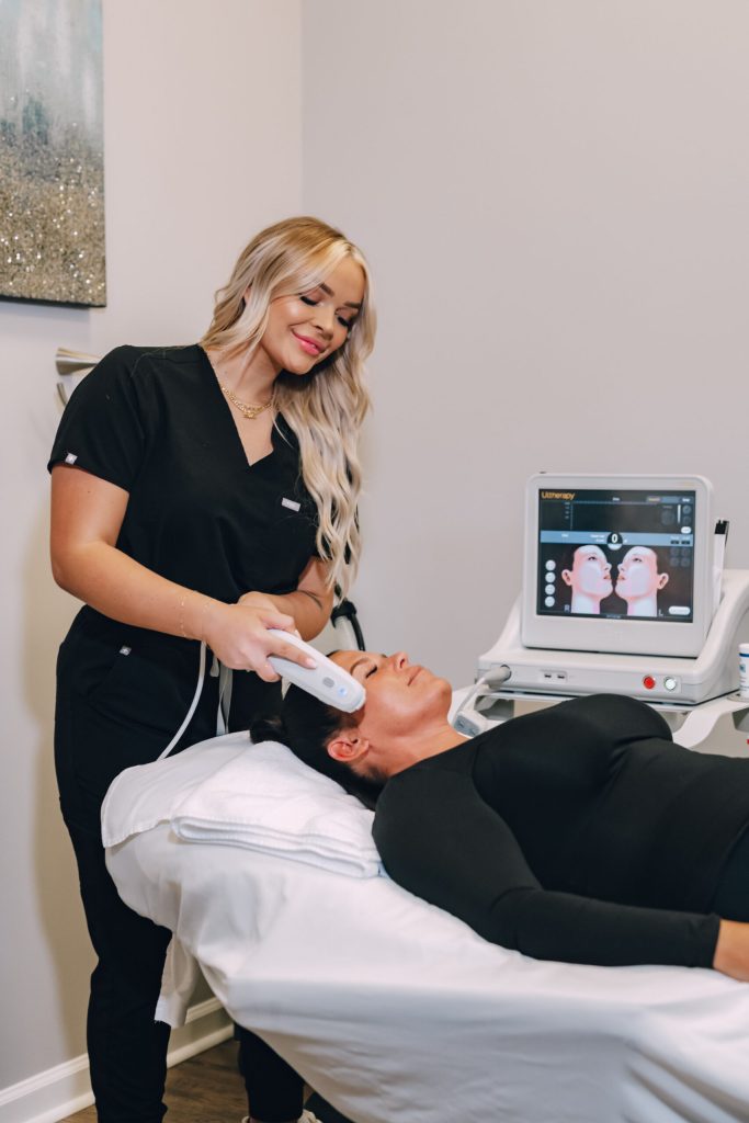 A Vibrant Med Spa aesthetician completing a laser treatment on a woman's face in their Crestwood, Kentucky spa.